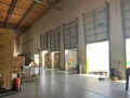 Interior view of US east overseas warehouse loading bays, stacked cartons and loading truck for cross-border order fulfillment