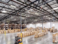 Spacious US fulfillment warehouse with stacked inventory and forklift